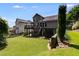 Sprawling backyard with a multi-level deck, lush lawn, and landscaping offering plenty of outdoor space at 81 Richmond Way, Villa Rica, GA 30180
