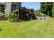 Lush, green backyard features a raised deck with stairs, landscaping, and outdoor seating at 81 Richmond Way, Villa Rica, GA 30180