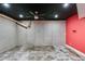 Spacious unfinished basement with concrete walls, ceiling fan, and red accent wall, ready for customization at 81 Richmond Way, Villa Rica, GA 30180