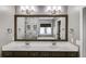Bathroom with a double sink vanity, large mirror, and a view of the tub and shower at 81 Richmond Way, Villa Rica, GA 30180