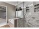 Bathroom showcasing a shower with decorative tiled walls and a soaking tub at 81 Richmond Way, Villa Rica, GA 30180
