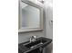Modern bathroom with a black sink and framed mirror at 81 Richmond Way, Villa Rica, GA 30180