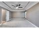 Spacious bedroom featuring a tray ceiling with fan and light-colored carpet at 81 Richmond Way, Villa Rica, GA 30180