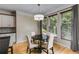 Eat-in kitchen dining area featuring a pendant light fixture and three large windows at 81 Richmond Way, Villa Rica, GA 30180