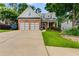 Inviting two-story home featuring a brick facade, well-maintained lawn and a concrete driveway at 81 Richmond Way, Villa Rica, GA 30180