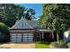 Charming brick home with a well-manicured lawn, featuring a two-car garage, inviting front porch, and mature trees at 81 Richmond Way, Villa Rica, GA 30180