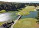 Scenic aerial view of golf course with pond and wooden walking bridge at 81 Richmond Way, Villa Rica, GA 30180