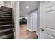Hallway leads to a kitchen with black appliances, tile backsplash and modern features at 81 Richmond Way, Villa Rica, GA 30180