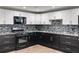 Modern kitchen features a stylish mosaic backsplash with sleek countertops at 81 Richmond Way, Villa Rica, GA 30180