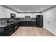 Modern kitchen featuring a sleek backsplash and black appliances at 81 Richmond Way, Villa Rica, GA 30180