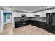 Modern kitchen with black and white cabinets and stainless steel appliances at 81 Richmond Way, Villa Rica, GA 30180
