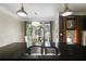Close-up of a kitchen island sink with granite countertops and pendant lighting fixtures at 81 Richmond Way, Villa Rica, GA 30180