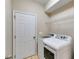 Laundry room with a white washer and dryer and wire shelving at 81 Richmond Way, Villa Rica, GA 30180