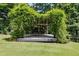 Outdoor wooden pergola covered with lush greenery, creating a serene and private backyard retreat at 81 Richmond Way, Villa Rica, GA 30180