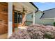 Covered porch showcasing brick columns and serene outdoor space at 81 Richmond Way, Villa Rica, GA 30180