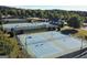 Aerial view of multiple well-maintained tennis courts surrounded by lush greenery, providing an excellent recreational space at 81 Richmond Way, Villa Rica, GA 30180