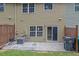 View of the back of the home with a small patio, air conditioning unit, and landscaping at 1649 Southgate Mill Nw Dr, Duluth, GA 30096