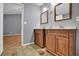 Bathroom featuring double vanities with wood cabinets and granite countertops at 1649 Southgate Mill Nw Dr, Duluth, GA 30096