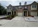 Charming townhome featuring brick facade, attached garage, and beautifully landscaped front yard at 1649 Southgate Mill Nw Dr, Duluth, GA 30096