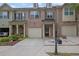 Three-story townhome with brick facade, attached garage, and manicured front yard at 1649 Southgate Mill Nw Dr, Duluth, GA 30096
