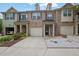 Three-story townhome with brick facade, attached garage, and well-maintained landscaping at 1649 Southgate Mill Nw Dr, Duluth, GA 30096