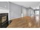 Open living space with hardwood flooring, a fireplace, and access to the staircase at 1649 Southgate Mill Nw Dr, Duluth, GA 30096