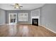 Spacious living room features hardwood floors, a ceiling fan, a fireplace and a sliding glass door at 1649 Southgate Mill Nw Dr, Duluth, GA 30096