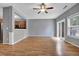 Open concept living room with hardwood floors, adjacent kitchen, and sliding glass doors at 1649 Southgate Mill Nw Dr, Duluth, GA 30096