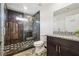 Modern bathroom with sleek tile shower, granite countertop vanity, and decorative floor tiles at 2711 Mcdonough Rd, Hampton, GA 30228