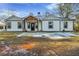Charming renovated one-story home with a black and white exterior and a wood-framed front porch at 2711 Mcdonough Rd, Hampton, GA 30228