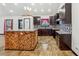 Eat-in kitchen with a wood accent island, dark cabinets, light countertops, and glazed tile flooring at 2711 Mcdonough Rd, Hampton, GA 30228
