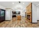 Renovated eat-in kitchen with dark cabinets, light countertops, and a wood accent island with glazed tile flooring at 2711 Mcdonough Rd, Hampton, GA 30228