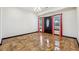 Open-concept living room with glazed tile flooring, light walls, and a view of the front door and windows at 2711 Mcdonough Rd, Hampton, GA 30228