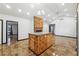 Open-concept living room with glazed tile flooring, light walls, and a wood accent kitchen island and fireplace at 2711 Mcdonough Rd, Hampton, GA 30228