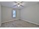 A bright bedroom with carpet floors, neutral walls, and a window with blinds at 4120 Buckley Woods Dr, Norcross, GA 30093