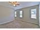 Spacious bedroom featuring a ceiling fan, three windows, and neutral carpeting at 4120 Buckley Woods Dr, Norcross, GA 30093