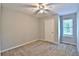 A bright bedroom featuring neutral walls, carpet floors, a window and a ceiling fan at 4120 Buckley Woods Dr, Norcross, GA 30093