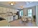 Well-lit kitchen with white cabinets, stainless steel appliances, and a cozy dining area, perfect for everyday meals at 4120 Buckley Woods Dr, Norcross, GA 30093