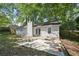 Backyard with patio, outdoor dining set and tree-lined fence at 971 Clover Ln, Lawrenceville, GA 30044