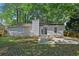 Beautiful backyard with patio and outdoor dining set, surrounded by lush trees at 971 Clover Ln, Lawrenceville, GA 30044