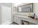 Well-lit bathroom featuring vanity, neutral walls, shower, and tile floors at 971 Clover Ln, Lawrenceville, GA 30044