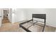 Inviting bedroom features neutral carpet and a sleek, modern bed frame at 971 Clover Ln, Lawrenceville, GA 30044