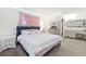 Cozy bedroom featuring neutral walls, carpet, and a large bed with decorative pillows at 971 Clover Ln, Lawrenceville, GA 30044
