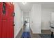 A bright entryway features hardwood floors, white walls, and a striking red front door at 971 Clover Ln, Lawrenceville, GA 30044