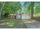 Charming single-story home featuring a stone facade, attached garage, and bright red front door at 971 Clover Ln, Lawrenceville, GA 30044