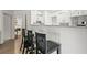 Eat-in kitchen with granite countertops, subway tile backsplash, breakfast bar, and stainless steel appliances at 971 Clover Ln, Lawrenceville, GA 30044