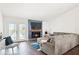 Cozy living room with a stone fireplace, large sectional sofa, and access to the patio at 971 Clover Ln, Lawrenceville, GA 30044