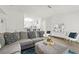 Open-concept living room with a large sectional, hardwood floors, and modern decor at 971 Clover Ln, Lawrenceville, GA 30044