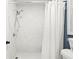 Modern shower with white marble-style tiles and a sleek showerhead at 971 Clover Ln, Lawrenceville, GA 30044