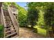 Backyard with stone walkway leads to deck with stairs and lush landscaping at 1121 Vinings Grove Se Way, Smyrna, GA 30082